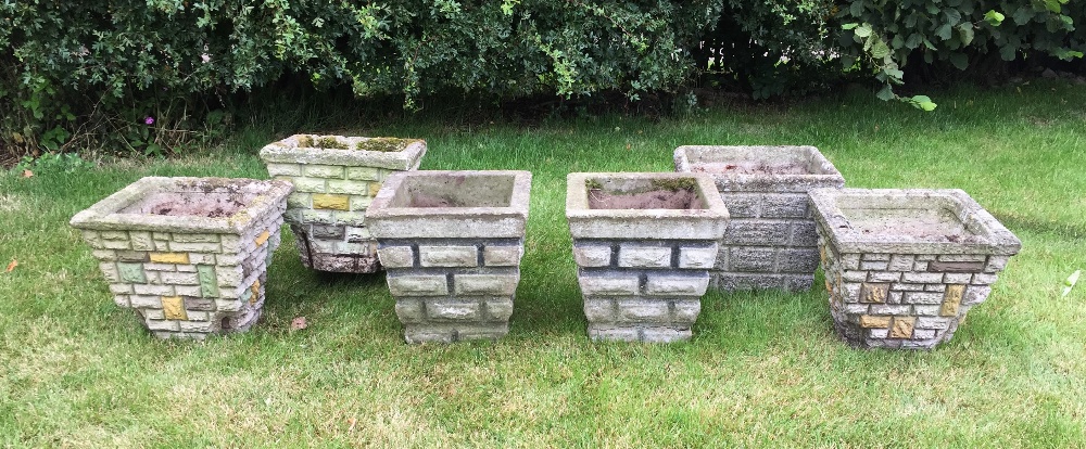 A selection of six reconstituted stone garden planters, each of tapered square form and with brick