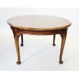 An early 20th century mahogany extending dining table, the circular moulded top raised upon cabriole