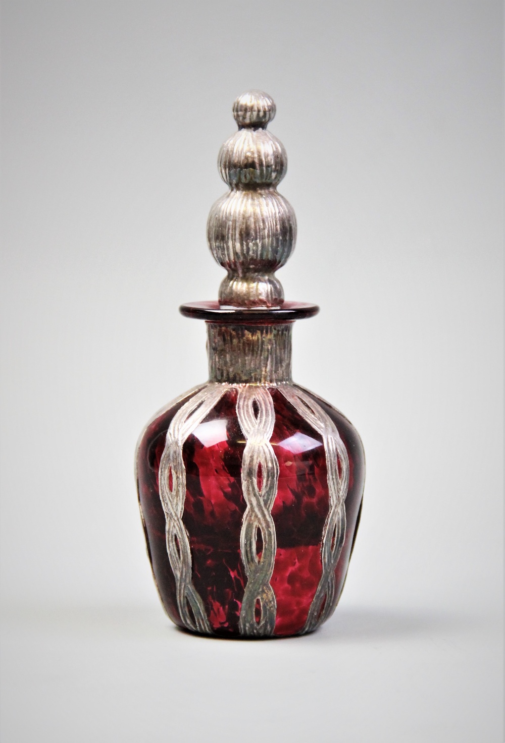A Continental silver mounted cranberry glass scent bottle, probably Spanish, 20th century (after