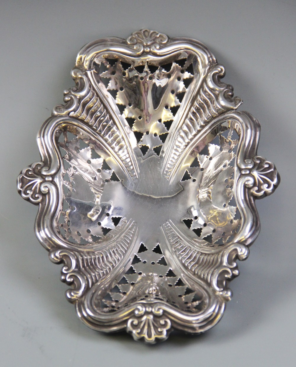 An Edwardian silver bonbon dish, S. Glass, Birmingham 1902, the dish with shaped rim and pierced