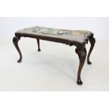 A George II style mahogany duet stool, late 19th century, the shaped tapestry seat raised upon