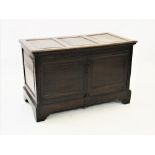 An 18th century oak mule chest, later converted to a cupboard, the rectangular top with three invert