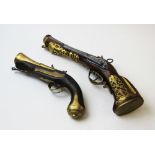 A large replica flintlock pistol set with pierced gilt brass decoration, 43cm long, with a smaller