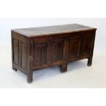 An 18th century oak coffer, the rectangular hinged lid above a frieze centred with initials and year