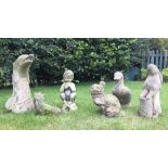 A group of six reconstituted stone garden animal sculptures, including a dolphin water fountain, a