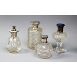 Three cut glass dressing table jars and an atomiser, including an Edwardian silver topped example,