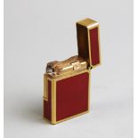 A Dupont of Paris gold plated and red enamelled lighter, of rectangular form, serial no. to base