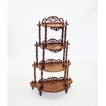 A Victorian mahogany what not, with four graduated half moon shelves each with a moulded scalloped