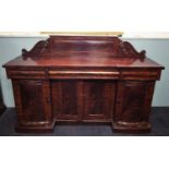 A William IV mahogany inverted breakfront sideboard, the raised panel back with moulded scroll