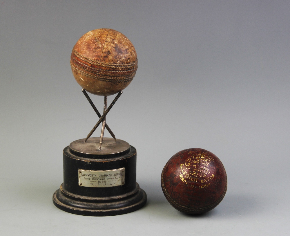 A cricket sporting trophy, comprising three white metal cricket stumps joined as a tripod stand