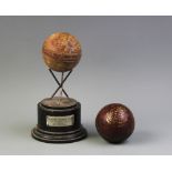 A cricket sporting trophy, comprising three white metal cricket stumps joined as a tripod stand