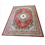 A Sarook Kashan silk rug, of traditional Persian design, with three graduated red, white and blue