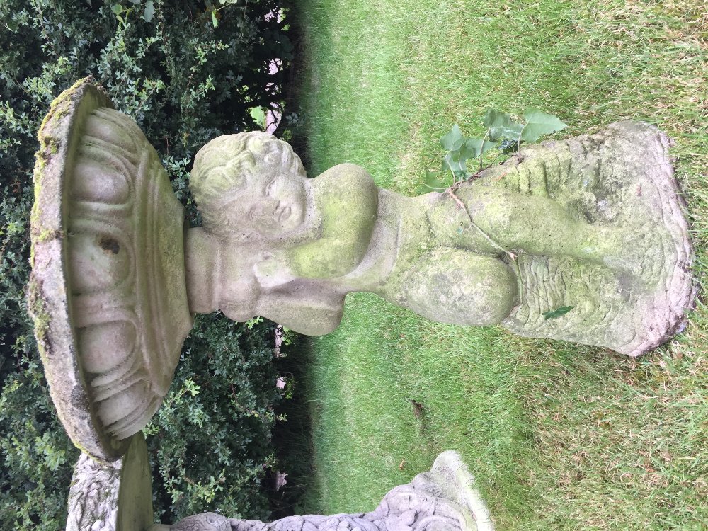 A reconstituted stone bird bath, designed as a cherub supporting a bowl shaped bath, 62cm high, with - Bild 2 aus 3