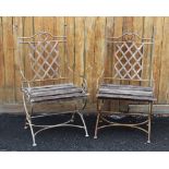 A pair of George III style metal strap work garden/patio chairs, each with a strap work panel