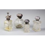 Three glass and silver topped dressing table jars, to include an Edwardian ovoid example by