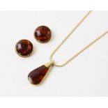 A suite of amber set 9ct gold jewellery, a tear-shaped 9ct gold pendant set with polished amber,