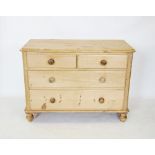 A Victorian pine chest of drawers, the rectangular moulded top with rounded front corners, above two