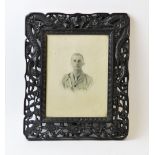 A carved wooden photograph frame, early 20th century, the tropical hardwood frame ornately