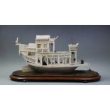 A 19th century Chinese carved ivory Canton Junk, circa 1880, intricately carved with side panels and