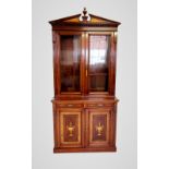 An Edwardian Sheraton revival mahogany library bookcase, the architectural pediment inlaid with