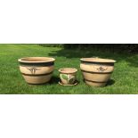 A pair of garden planters, each of cream tapering circular form with brown banded detail and a