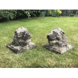 A pair of reconstituted stone lions masks/heads, each on square back, 29cm H x 30cm square (2)