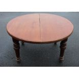 A Victorian mahogany dining table, the circular moulded top raised upon lobed and fluted legs,