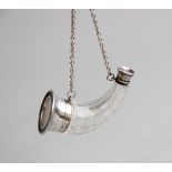 A novelty horn shaped cut glass scent bottle, of tapering form with white metal mounts, hinged lid
