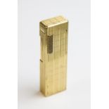 A Colibri gold plated lighter, of rectangular form with engine turned decoration to exterior,