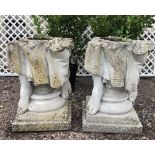 Two reconstituted stone planters modelled as the base of a figural statue with two feet and drapery,