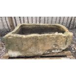 A large sandstone trough, of rectangular form with one convex end, 41cm H x 115cm W x 68cm D