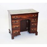 A 19th century mahogany knee hole desk, the rectangular top with an inset leather writing surface,