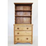A 20th century pine kitchen dresser, with two graduated shelves upon an associated chest with