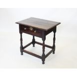 An early 18th century oak side table, the rectangular moulded top above a single frieze drawer