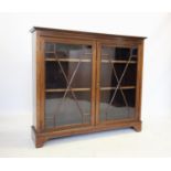 An Edwardian mahogany display cabinet by Maple & Co, London, the rectangular cross banded top