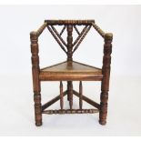 A late 19th century oak turners chair, the ring incised and ring turned top rail extending to down