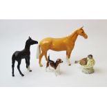 A Beswick Palomino horse, modelled standing, maker's mark to underside, 17.5cm high, with a