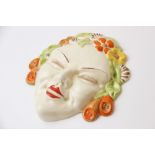 A Clarice Cliff Bizarre wall mask, Flora, circa 1936, relief moulded with floral hair in green,
