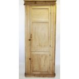 A Victorian pine free standing corner cupboard, with a moulded cornice above two pairs of panelled