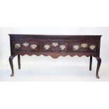 A George III oak dresser, the rectangular moulded top above a plain frieze and three drawers each