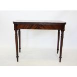 An early 19th century mahogany folding tea table, the rectangular top with rounded front corners and