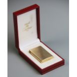 A 9ct gold Must de Cartier lighter, of rectangular form, hallmarks and serial number to base, 56mm x