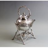 A silver plated Aesthetic movement spirit kettle, early 20th century, the kettle with cast