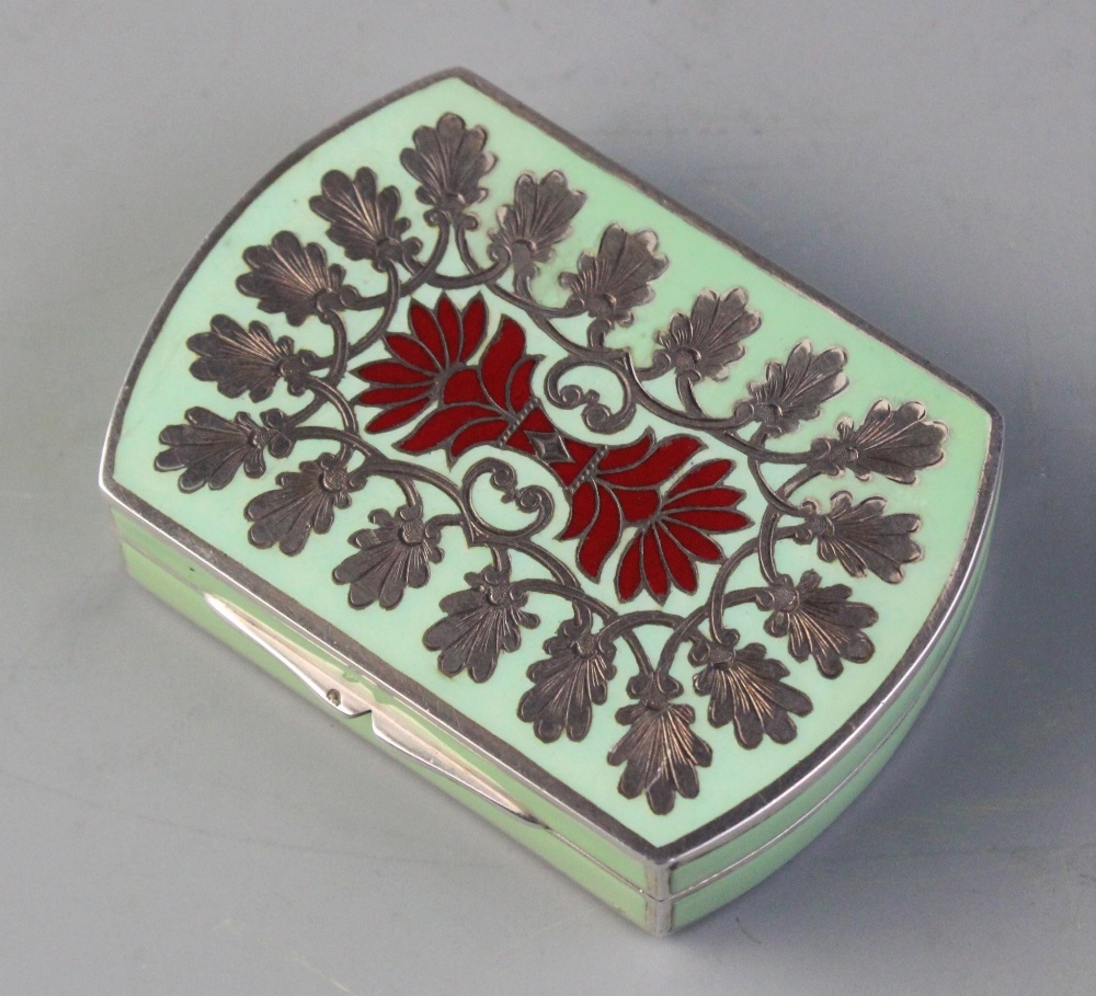 A silver, green and red enamelled minaudiere with internal rouge pot, mirror and lipstick, chased