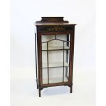 An Edwardian mahogany display cabinet, with painted foilate swags above a single glazed door,