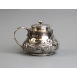 A George III silver mustard pot, London 1819, of squat baluster form with hinged lid, repousee
