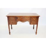 An early 19th century mahogany dressing table, the rectangular top above an arrangement of five