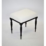 A late 19th century aesthetic movement mahogany foot stool, the rectangular re upholstered top above