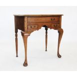 An early 19th century oak low boy, the rectangular moulded top above one long and two short drawers,