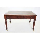 A Victorian mahogany writing desk, the rectangular moulded top inset with a gilt tooled leather